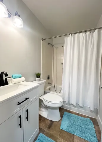 a bathroom with a sink toilet and shower