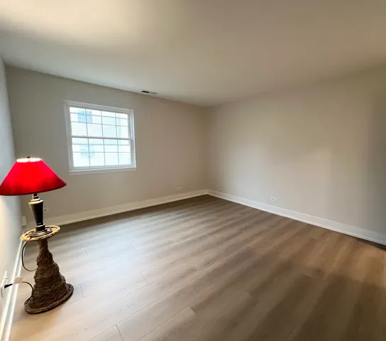 a view of a room with a large window a table and chairs