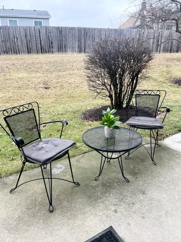 a view of a chairs and table in patio
