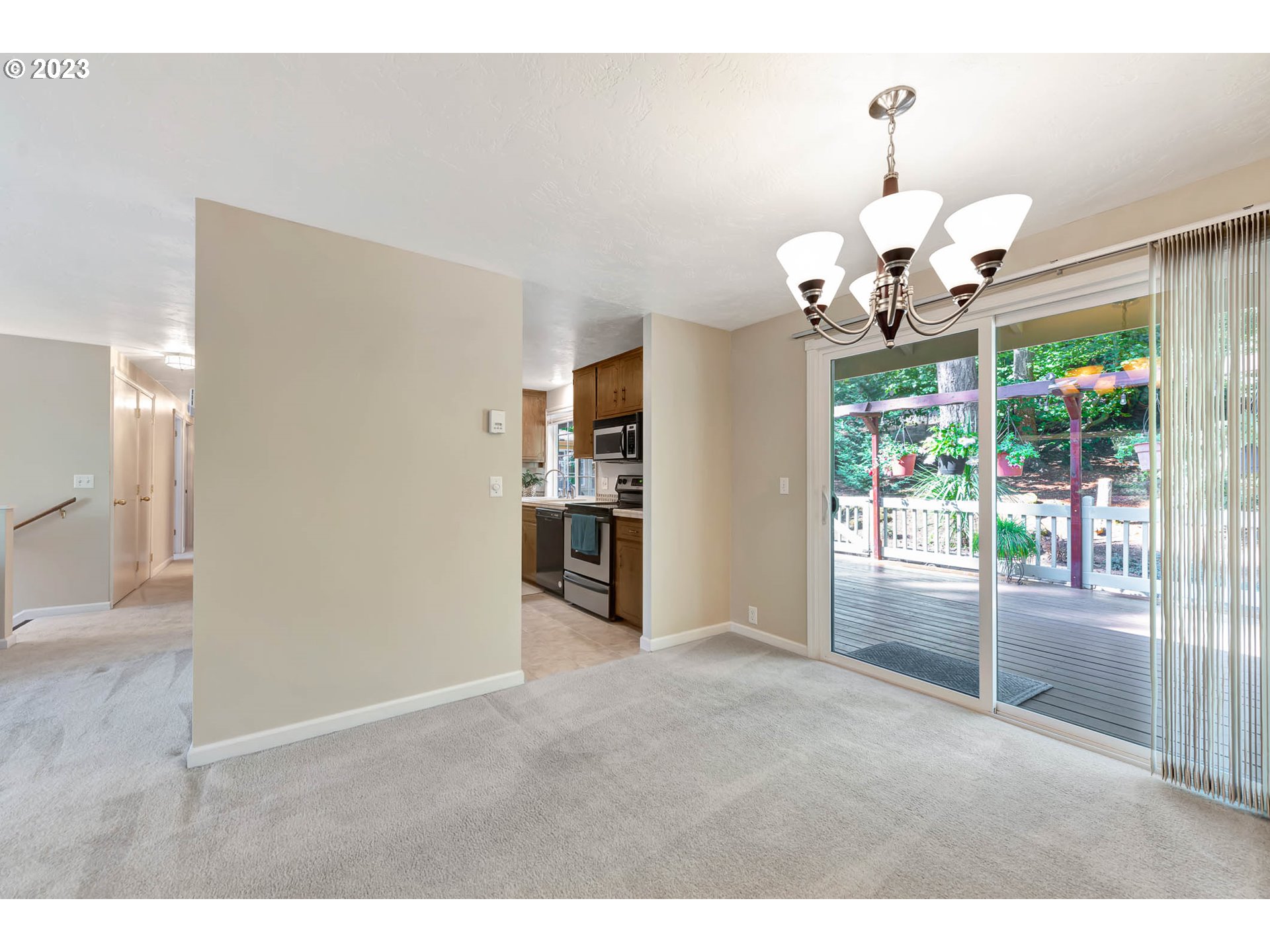 2817 Greentree Way Eugene, OR 97405 - Photo 12 of 44 a view of a livingroom with kitchen and dining area with chandelier