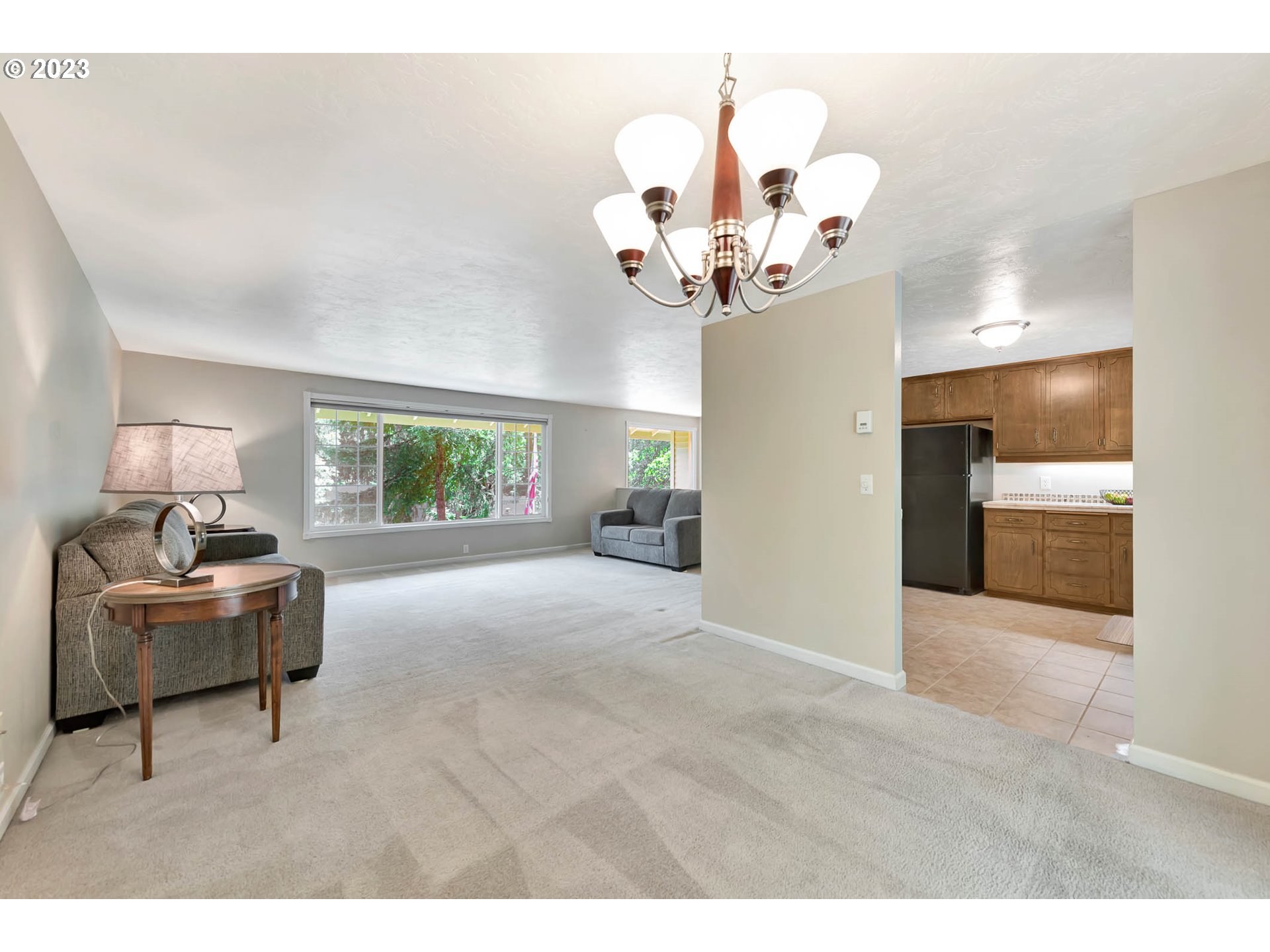 2817 Greentree Way Eugene, OR 97405 - Photo 13 of 44 a view of a livingroom with a chandelier furniture and windows