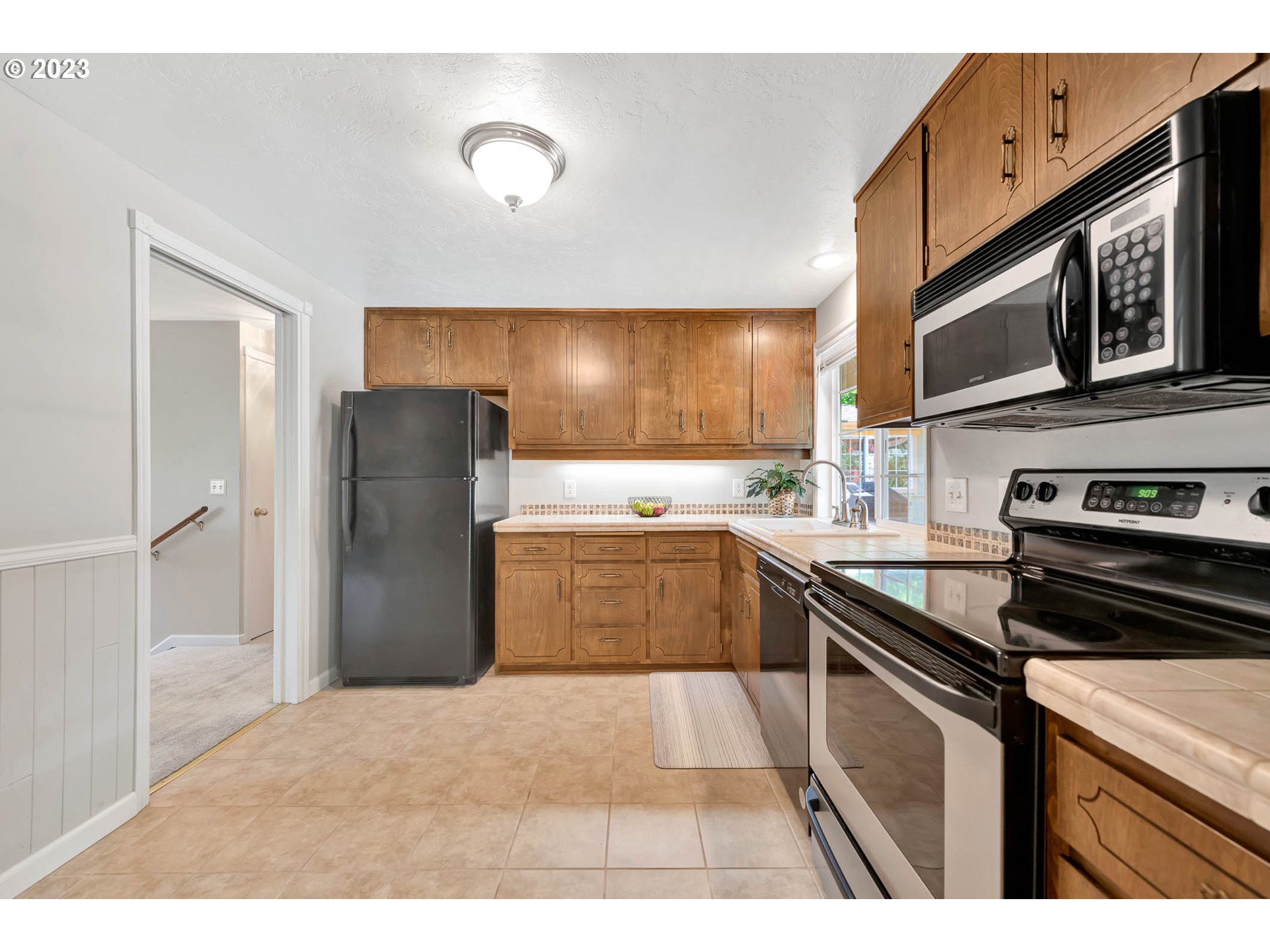 2817 Greentree Way Eugene, OR 97405 - Photo 14 of 44 a kitchen with a refrigerator sink and stove top oven