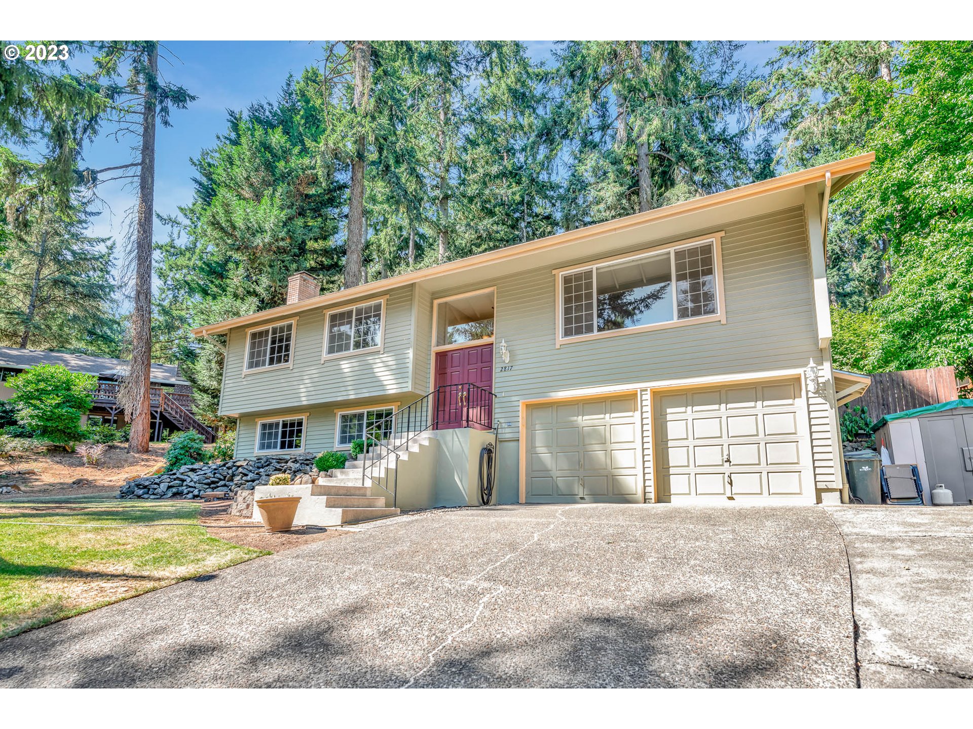 2817 Greentree Way Eugene, OR 97405 - Photo 2 of 44 a front view of a house with a yard and fountain in middle