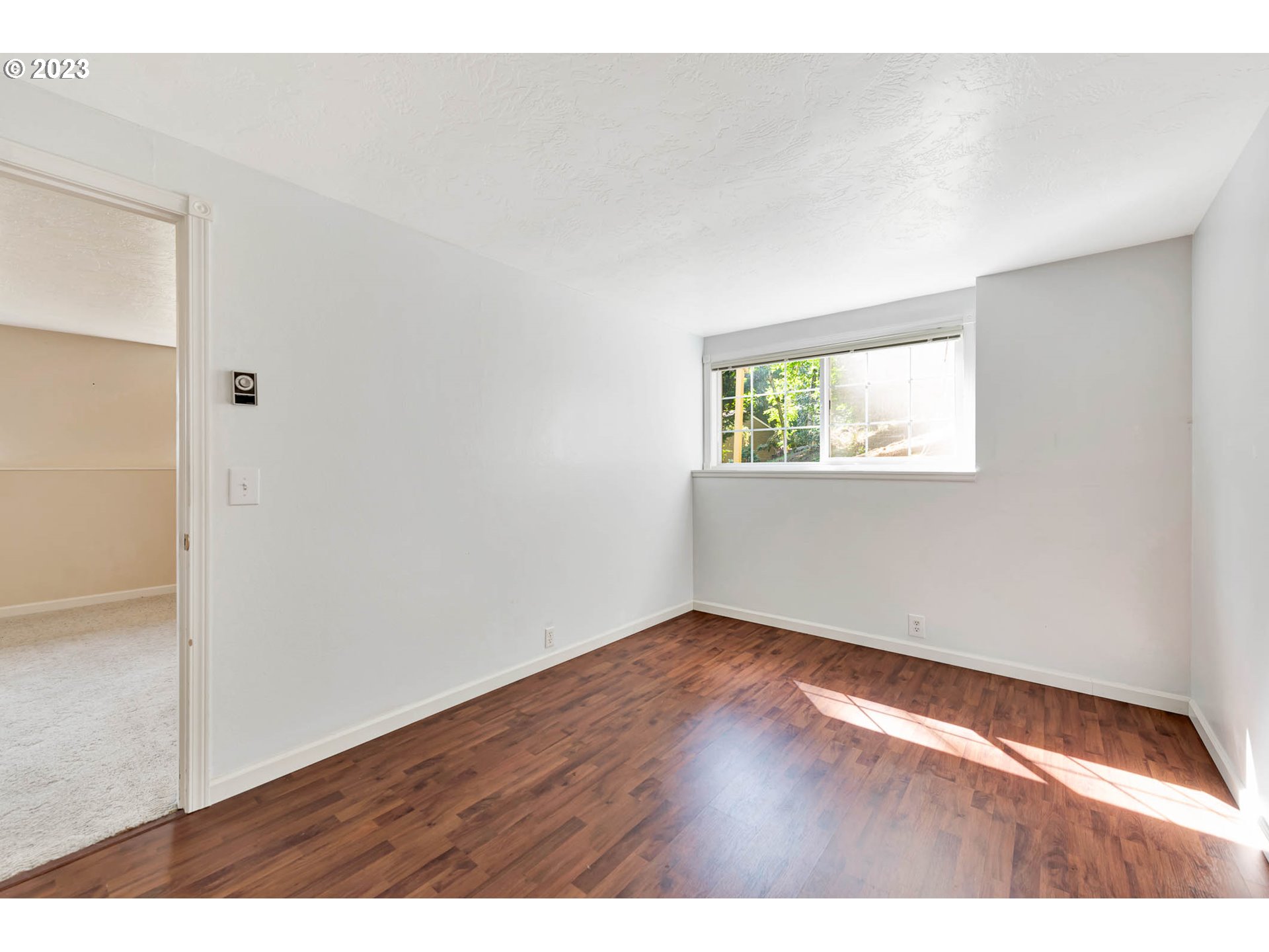 2817 Greentree Way Eugene, OR 97405 - Photo 33 of 44 an empty room with wooden floor and windows