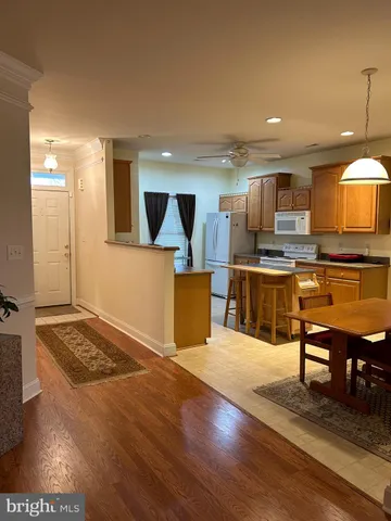 a view of kitchen with cabinets and wooden floor