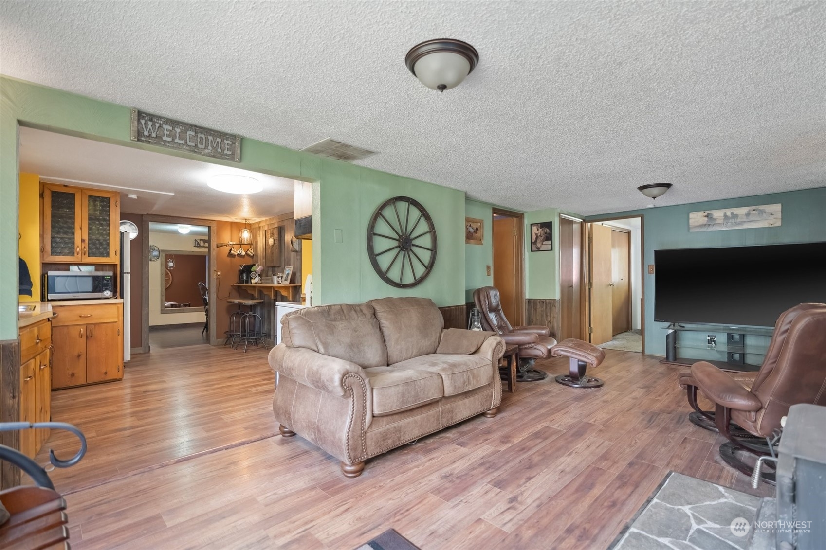 258 Coulson Road Chehalis, WA 98532 - Photo 16 of 37 a living room with furniture a flat screen tv and a large window