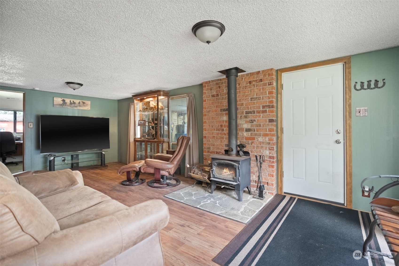 258 Coulson Road Chehalis, WA 98532 - Photo 17 of 37 a living room with furniture a flat screen tv and a large window