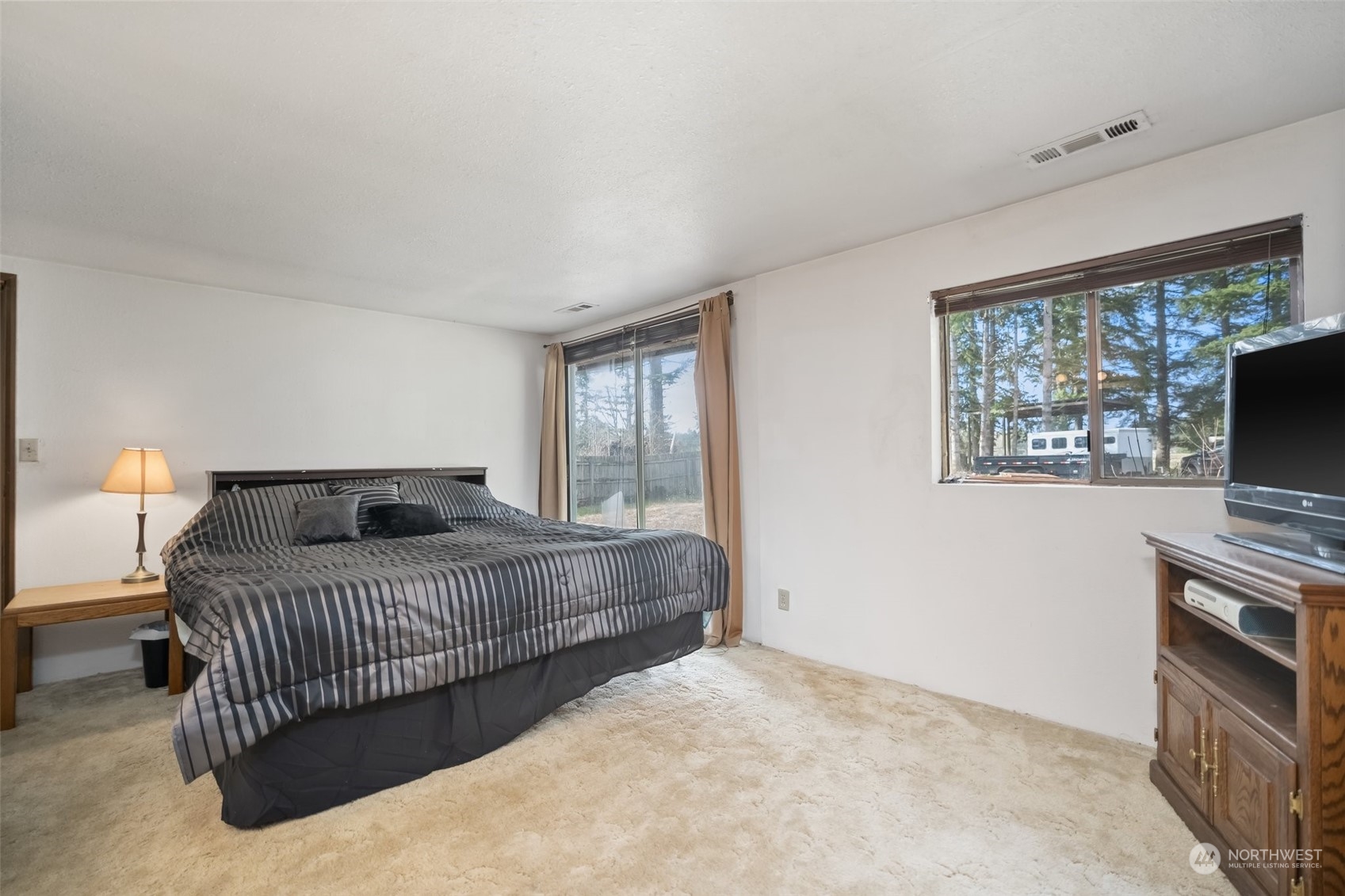 258 Coulson Road Chehalis, WA 98532 - Photo 20 of 37 a bedroom with a bed and a flat screen tv