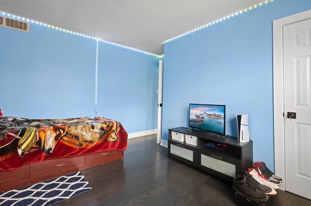 a bedroom with a bed and dresser