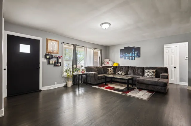 a living room with furniture window and wooden floor