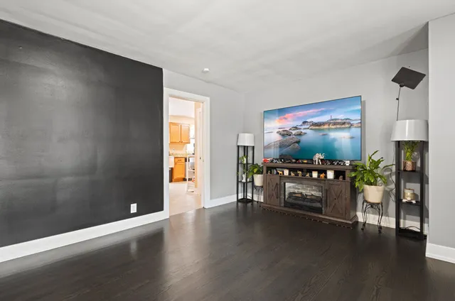 a dining room with furniture and wooden floor