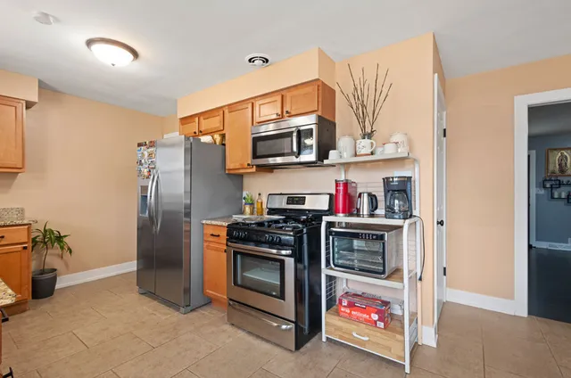 a kitchen with stainless steel appliances granite countertop a stove and a refrigerator