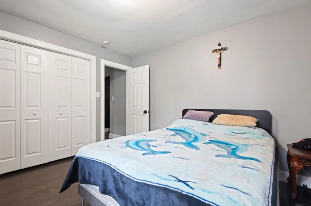 a bedroom with a bed and a dresser