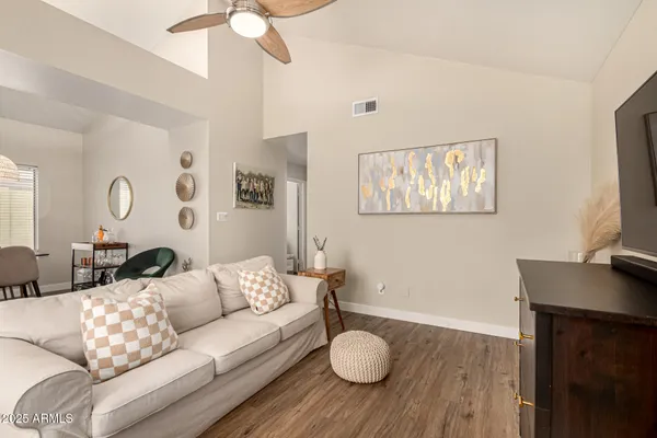 a living room with kitchen island furniture and a chandelier