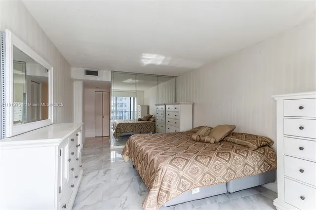 a bedroom with a bed and a dresser