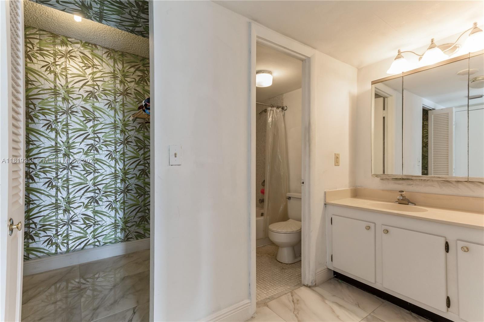 9273 Collins Avenue, Unit 1101 Surfside, FL 33154 - Photo 14 of 22 a spacious bathroom with a granite countertop sink a toilet and a shower