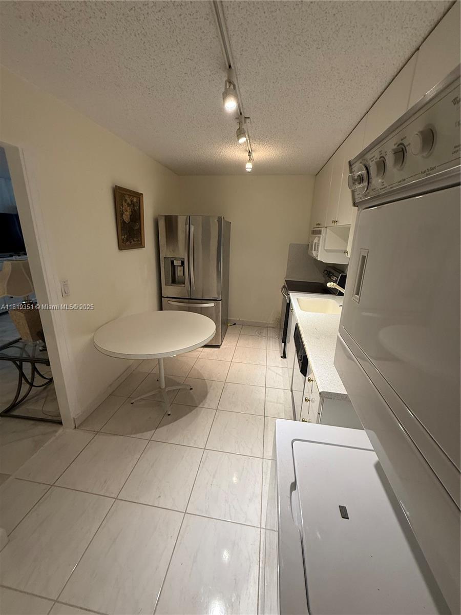 9273 Collins Avenue, Unit 1101 Surfside, FL 33154 - Photo 6 of 22 a bathroom with a sink toilet and mirror