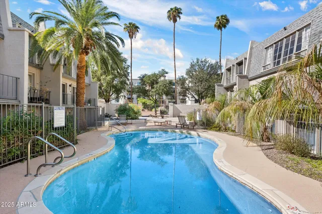a swimming pool with outdoor seating and yard