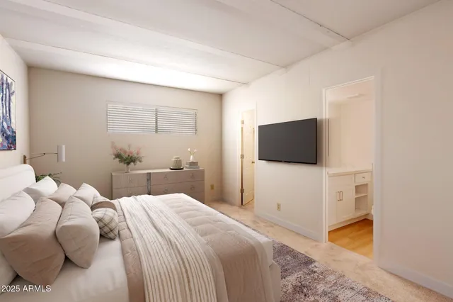 a bedroom with a bed and a flat screen tv