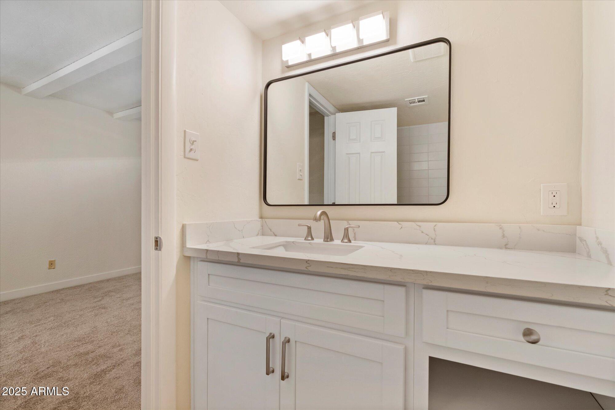 1014 East Osborn Road, Unit A Phoenix, AZ 85014 - Photo 14 of 25 a bathroom with a sink vanity and mirror