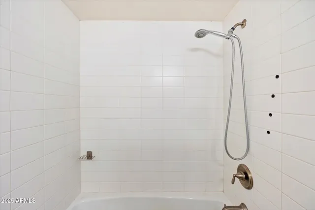 a bedroom with a bed and glass door