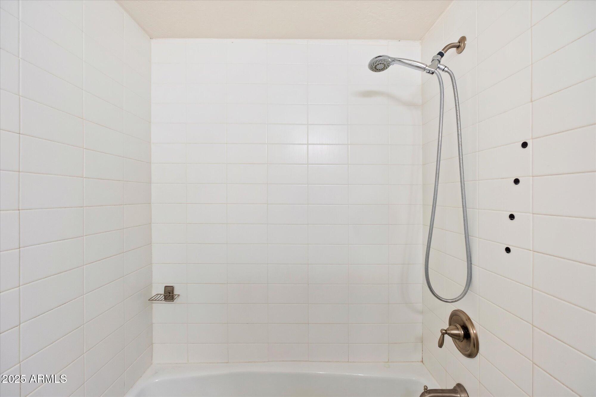 1014 East Osborn Road, Unit A Phoenix, AZ 85014 - Photo 15 of 25 a bathroom with a bath tub with a shower