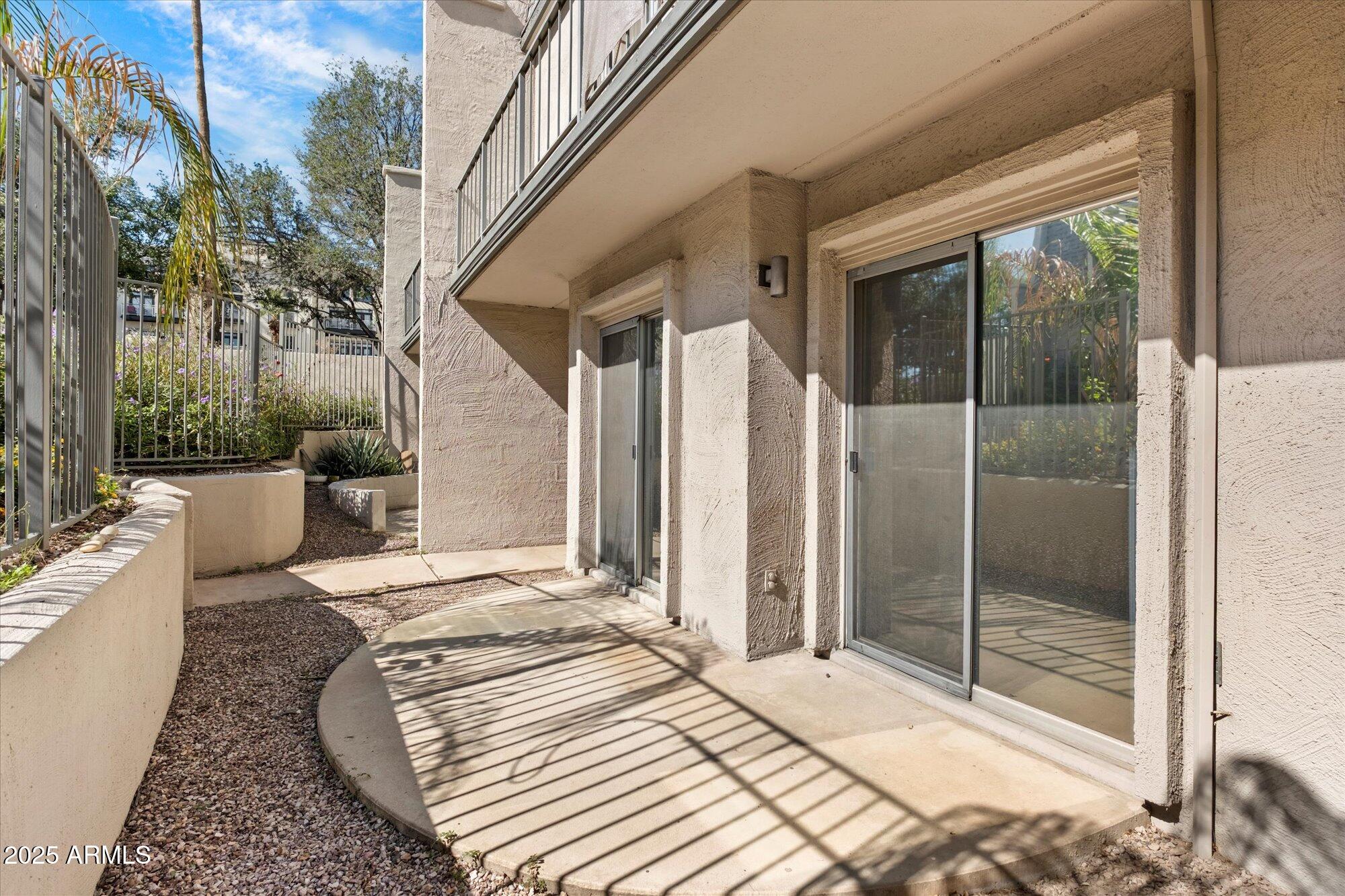 1014 East Osborn Road, Unit A Phoenix, AZ 85014 - Photo 17 of 25 a bedroom with a bed and glass door