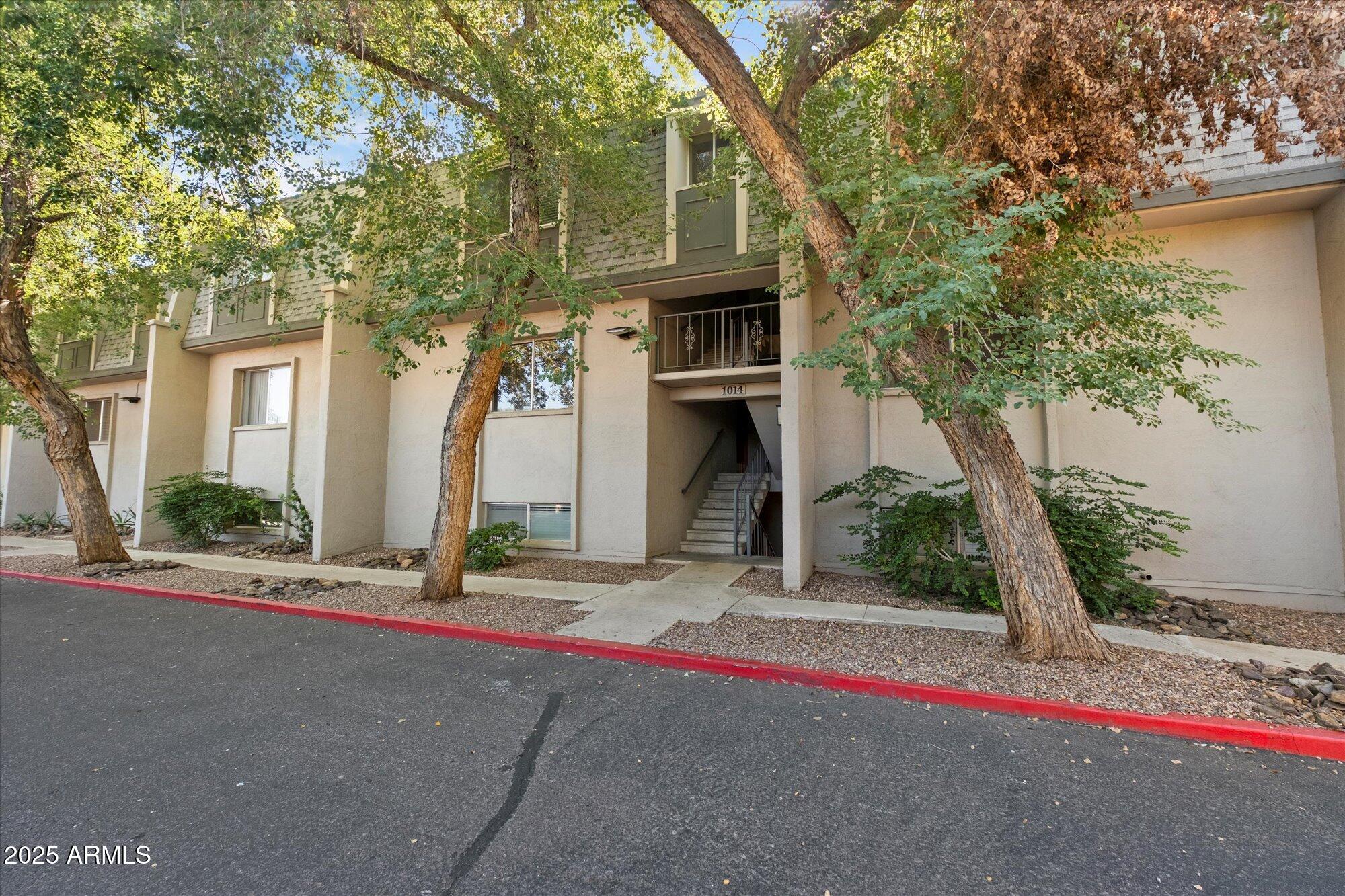 1014 East Osborn Road, Unit A Phoenix, AZ 85014 - Photo 24 of 25 a front view of a house with a yard and a garage