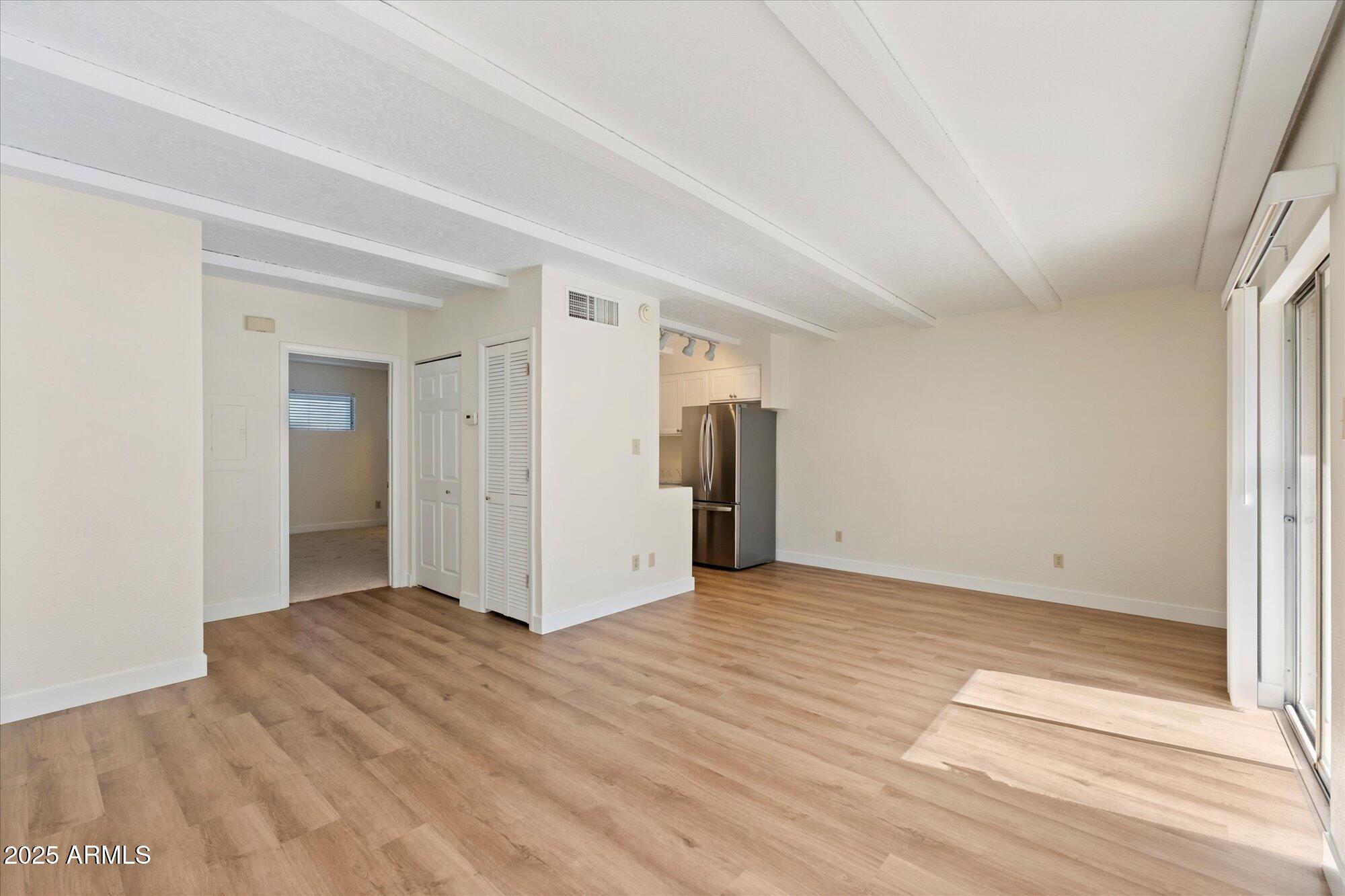 1014 East Osborn Road, Unit A Phoenix, AZ 85014 - Photo 5 of 25 a view of an empty room with wooden floor