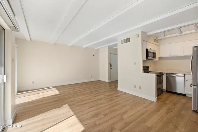 a view of a kitchen with a sink and a refrigerator