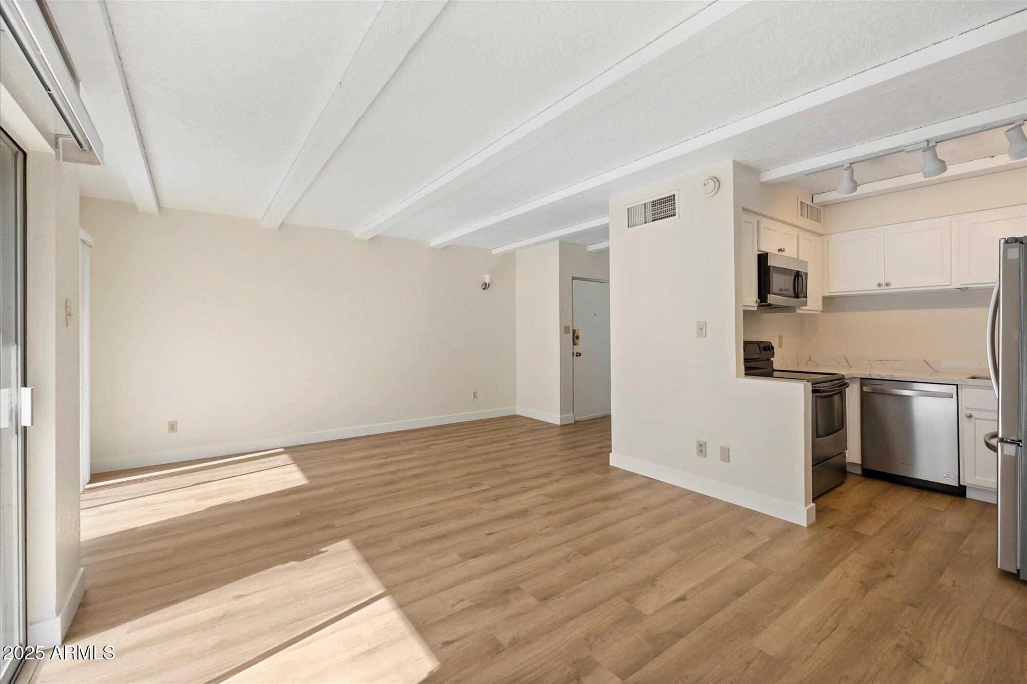 1014 East Osborn Road, Unit A Phoenix, AZ 85014 - Photo 7 of 25 a view of a kitchen with a sink and a refrigerator