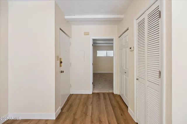 a view of a hallway with wooden floor