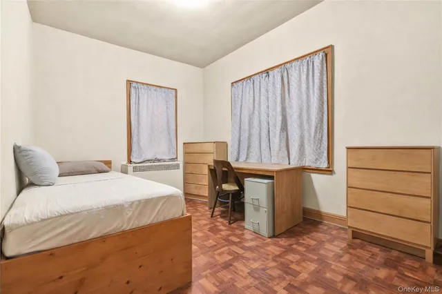 a room with a bed and a dresser