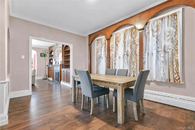 a view of a a dining room with furniture window and wooden floor