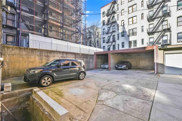 a view of building with car parked