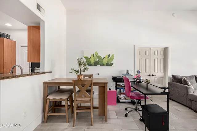 a dining room with furniture and a potted plant