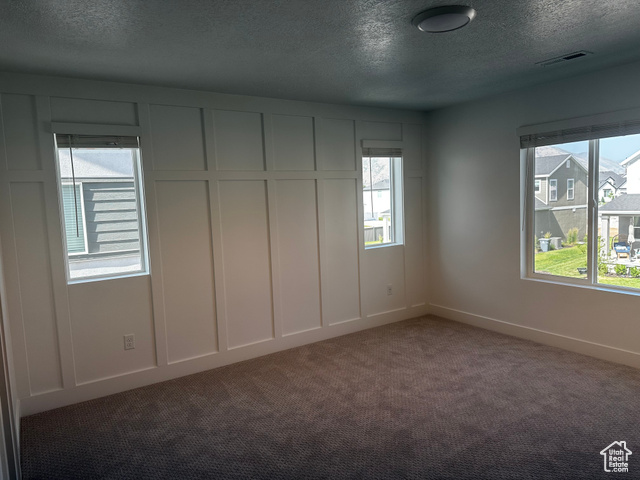 22 South Starlight Lane Mapleton, UT 84664 - Photo 7 of 17 Carpeted spare room with a textured ceiling and baseboards