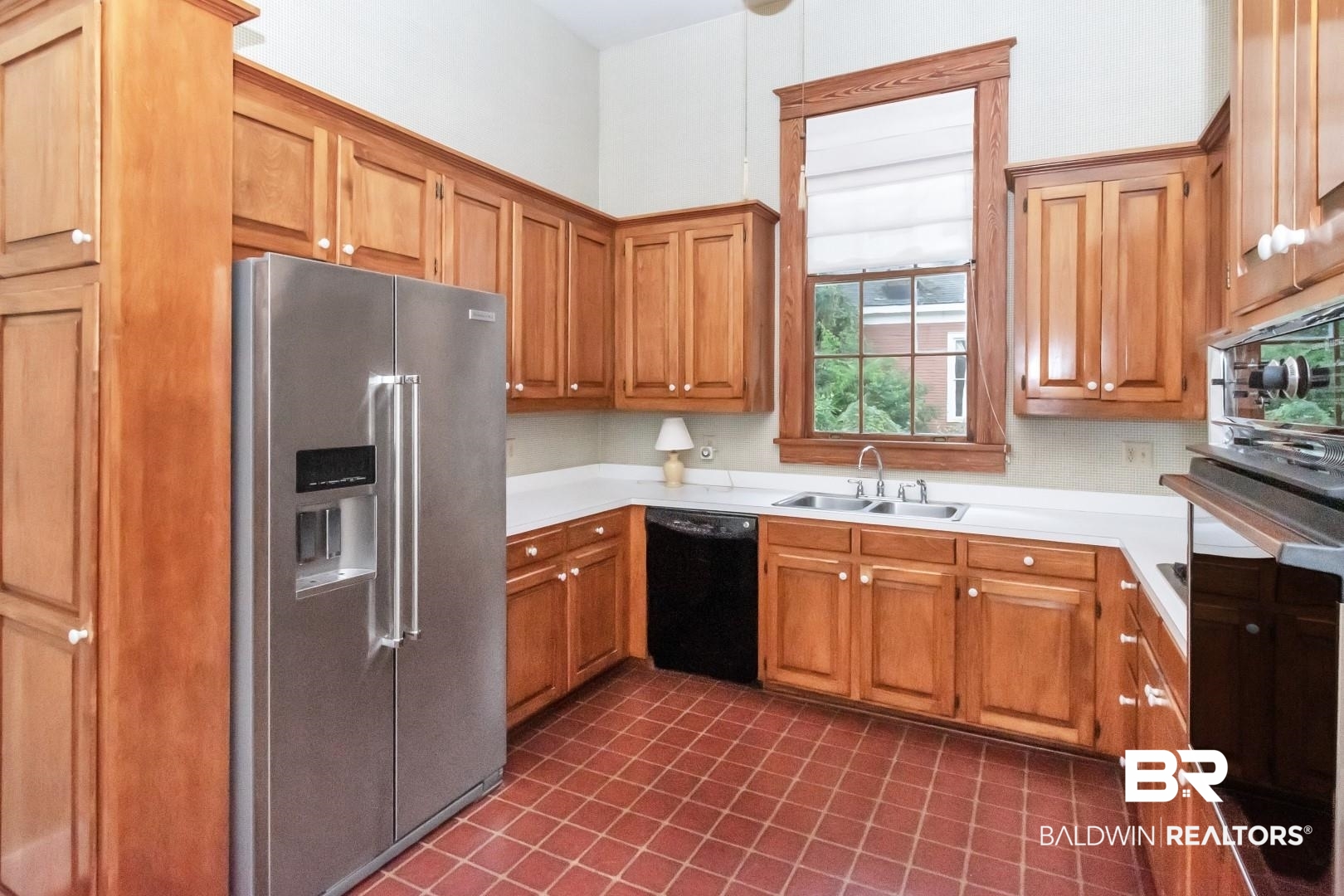959 Dauphin Street Mobile, AL 36604 - Photo 11 of 43 Kitchen with sink, high end refrigerator, black dishwasher, and dark tile patterned flooring