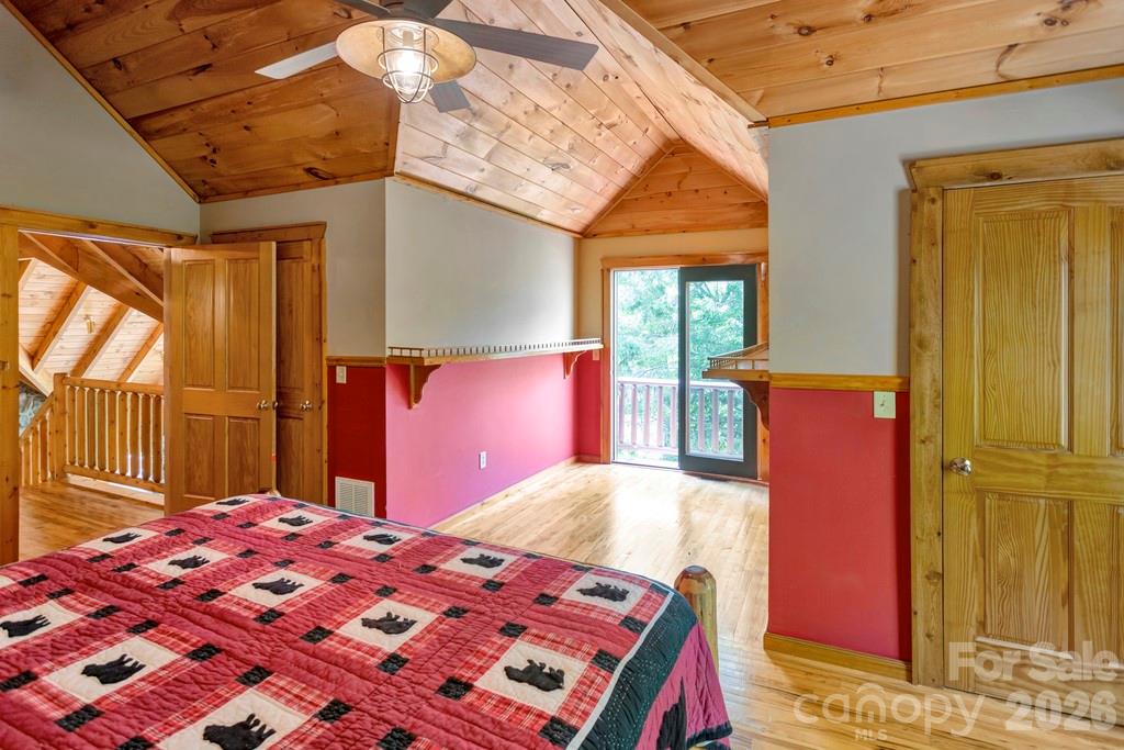 35 Falcon Crest Loop Maggie Valley, NC 28751 - Photo 20 of 46 a bedroom with a bed and a chandelier
