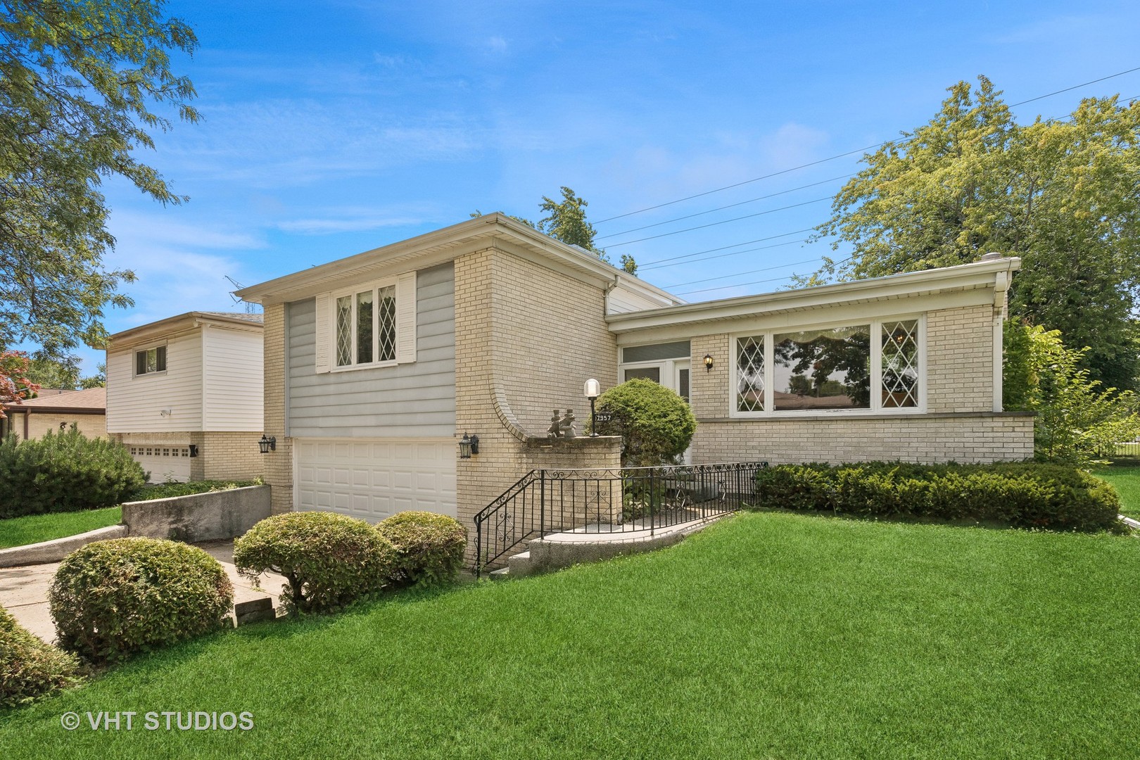 a front view of a house with a garden
