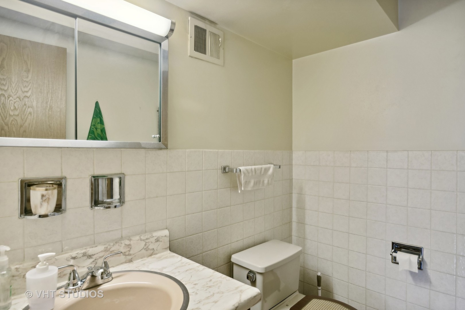 7957 Beckwith Road Morton Grove, IL 60053 - Photo 19 of 26 a bathroom with a sink and a toilet