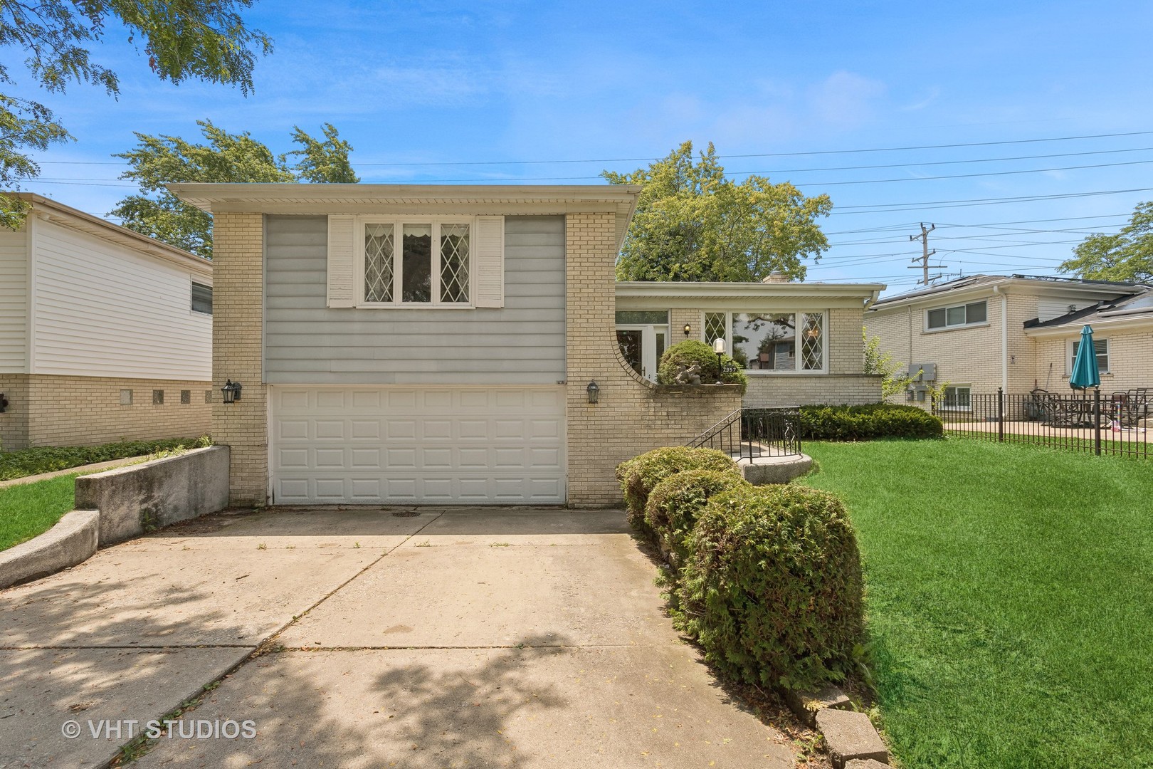 7957 Beckwith Road Morton Grove, IL 60053 - Photo 2 of 26 a front view of a house with a yard