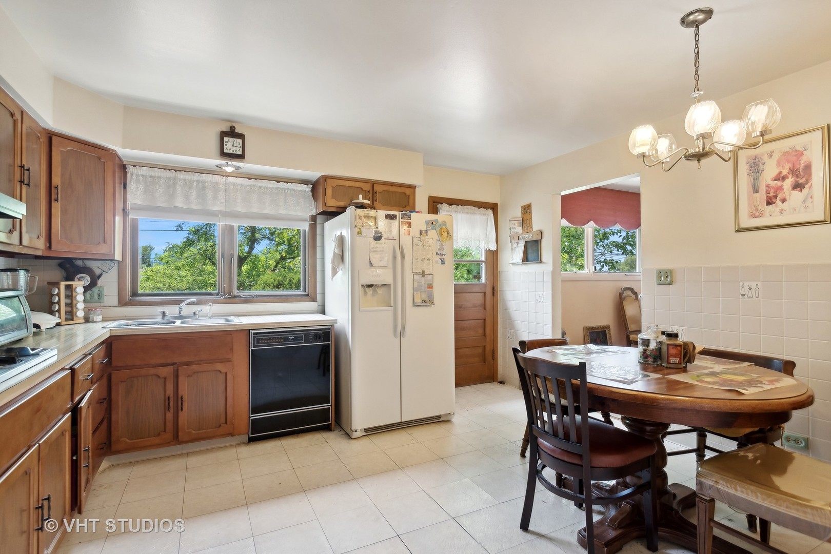 7957 Beckwith Road Morton Grove, IL 60053 - Photo 8 of 26 a view of a dining room and kitchen with a table chairs