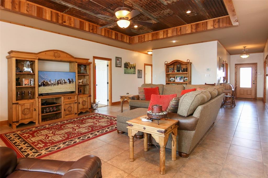 7158 Luella Road Sherman, TX 75090 - Photo 7 of 40 a living room with furniture and a flat screen tv