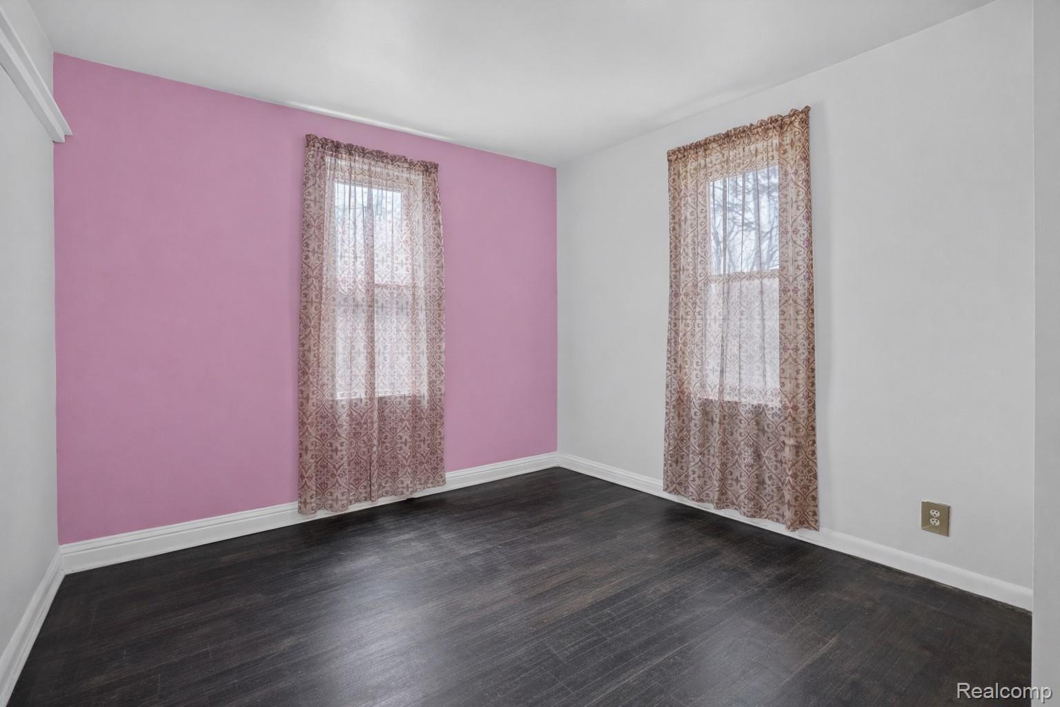 13343 Fenton Road Fenton, MI 48430 - Photo 10 of 45 Spare room featuring dark wood-type flooring and plenty of natural light