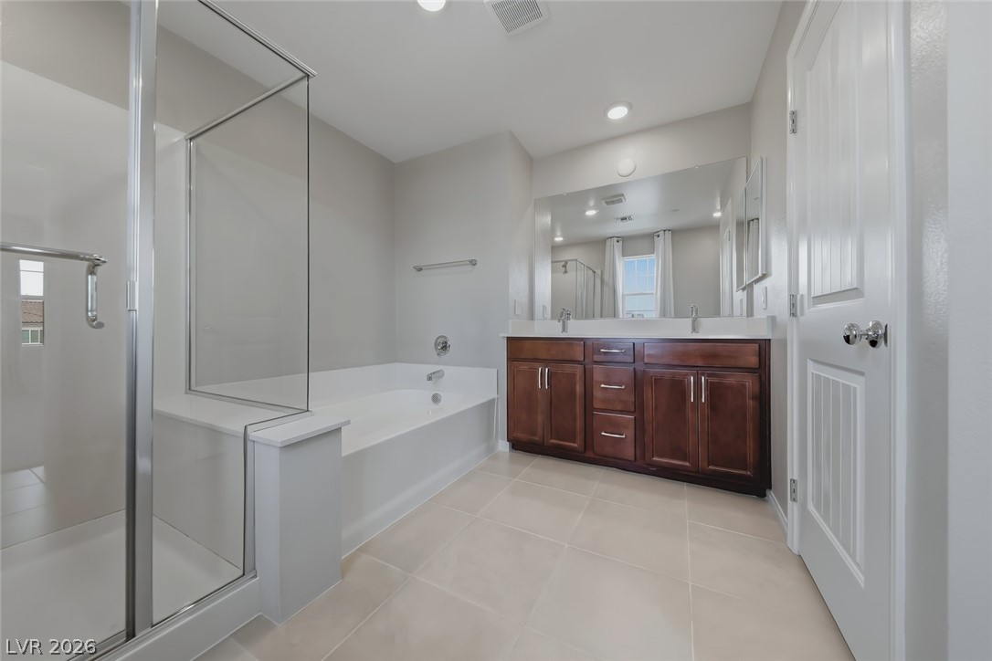 3564 Credere Lane Henderson, NV 89074 - Photo 20 of 40 Bathroom with a stall shower, double vanity, a garden tub, light tile patterned floors, and recessed lighting