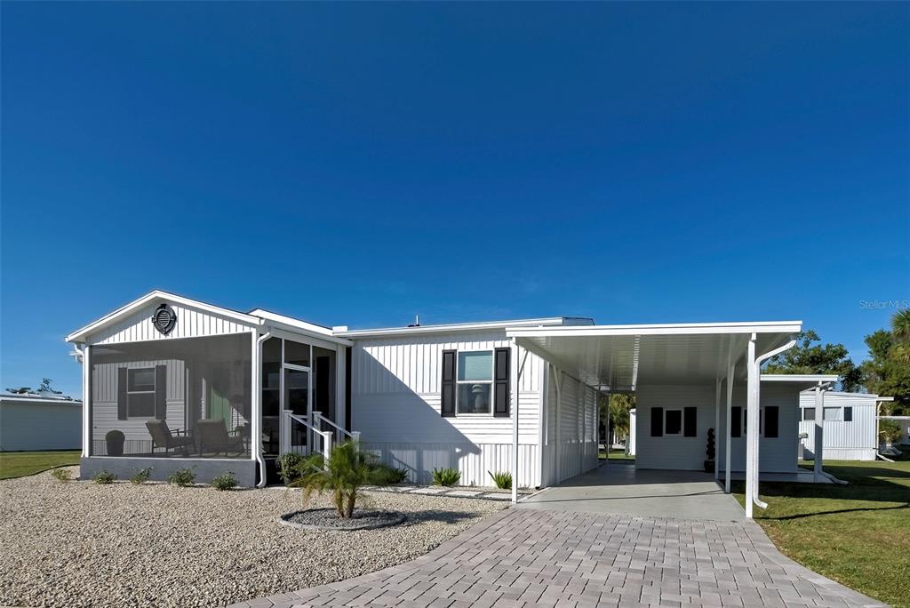 6230 Teahouse Road Venice, FL 34293 - Photo 1 of 1 a front view of a house with garden