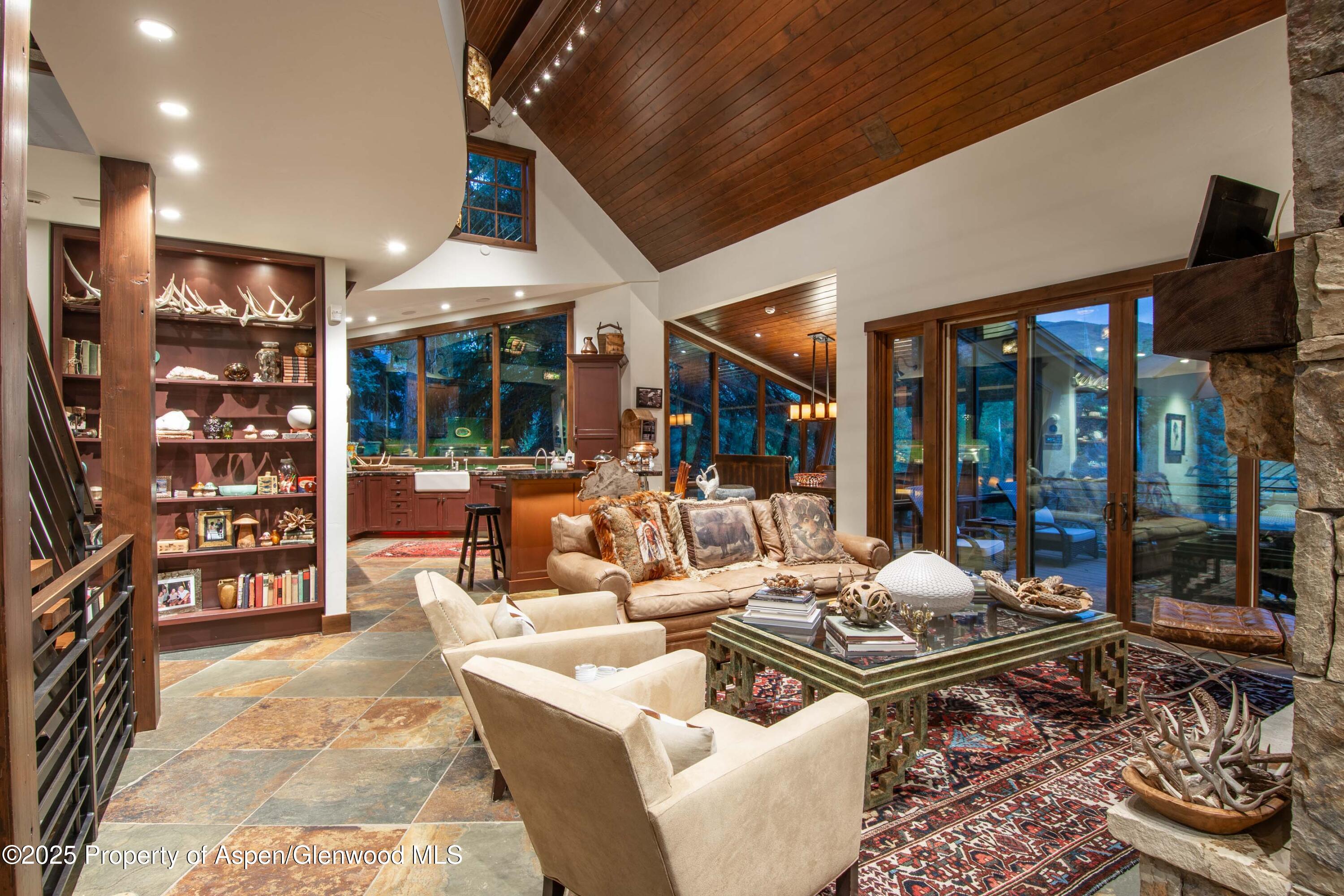4076 Lower River Road Snowmass, CO 81654 - Photo 12 of 71 a living room with furniture a rug and a floor to ceiling window