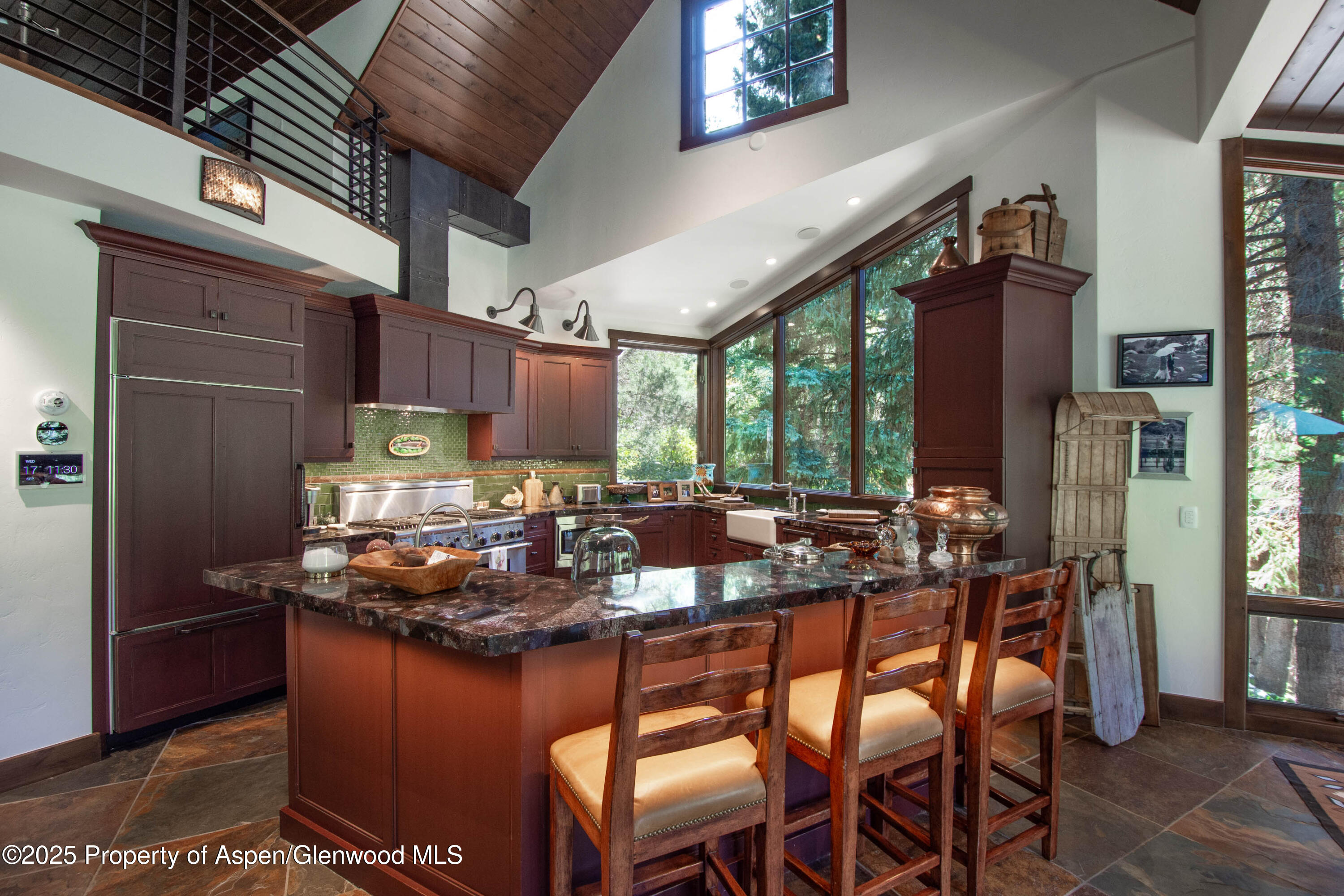 4076 Lower River Road Snowmass, CO 81654 - Photo 14 of 71 a kitchen with stainless steel appliances granite countertop table chairs and a refrigerator