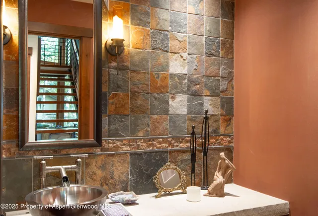 a bathroom with a glass shower door